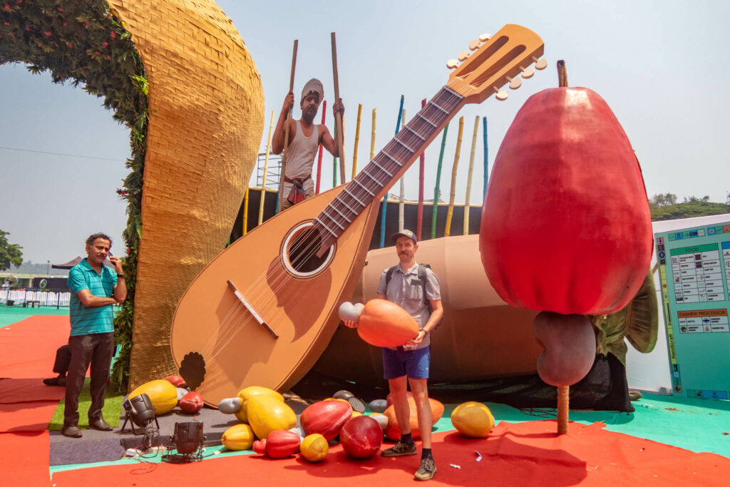 the man is holding a large cashew and there is also a guitar