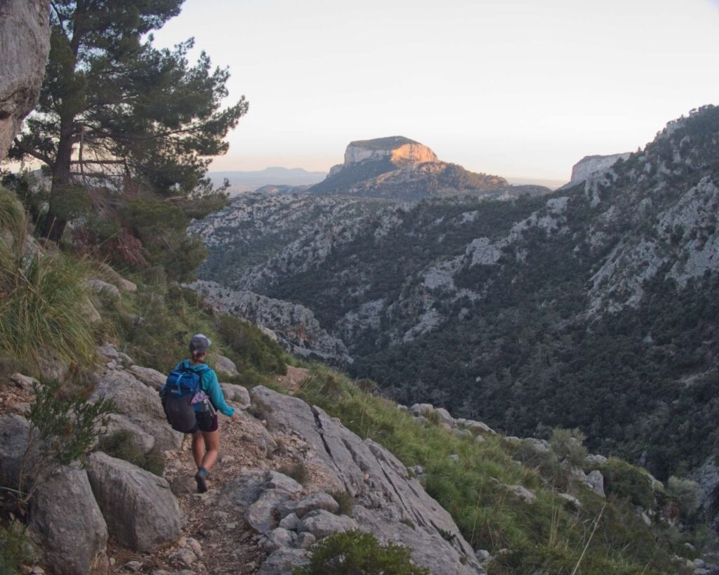 woman walking with Puig d'Alaro in the background